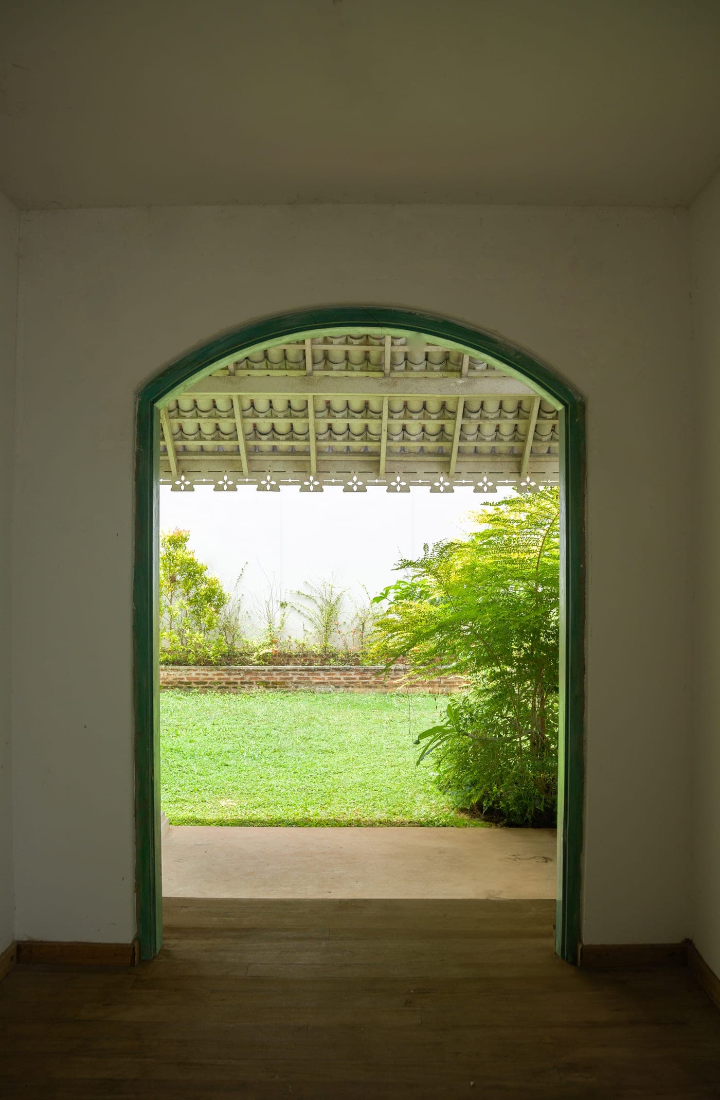 Looking out through the arched veranda of a colonial home in Kandy